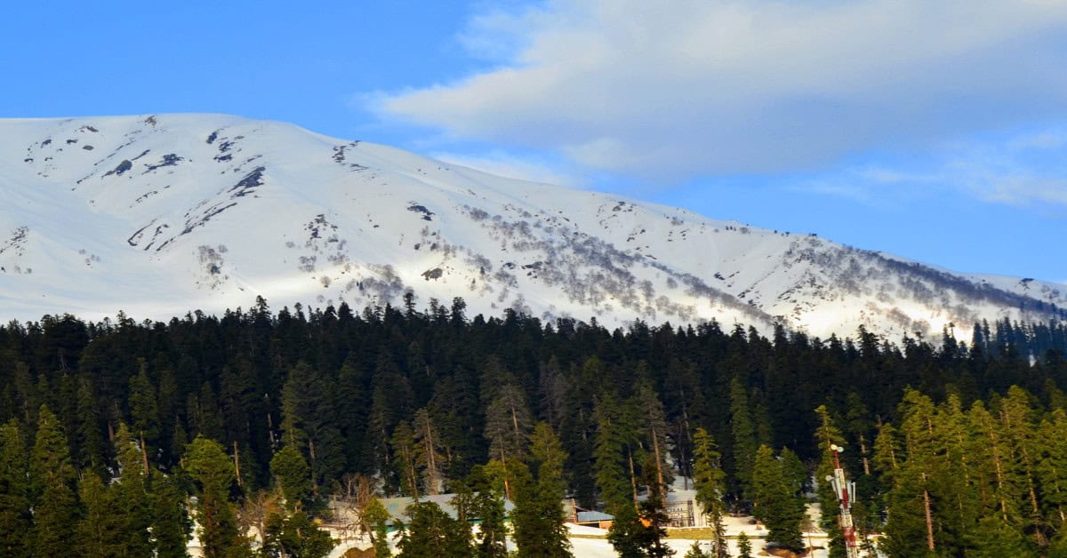 A scenic view of Gulmarg, Kashmir, showcasing top tourist places amidst majestic mountains
