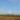 Wind turbines generating renewable energy in an open field under a clear sky.