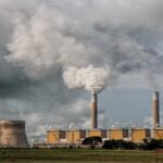 Factory emitting thick smoke, symbolizing air pollution and its environmental impacts