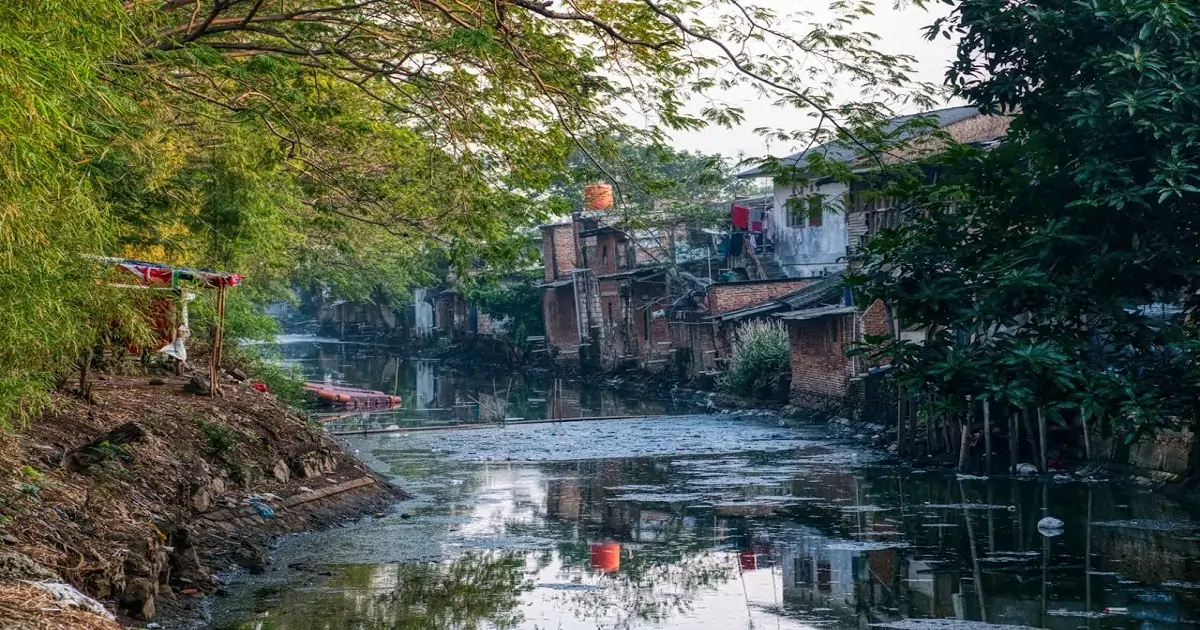 Polluted urban canal receiving sewage and household waste from nearby settlements