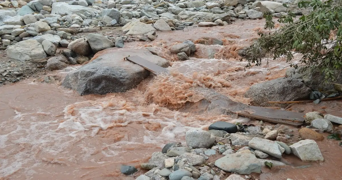 Muddy stream carrying soil and sediments after rainfall due to natural erosion