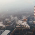 Factory chimney releasing smoke, representing air pollution as a major global environmental issue caused by industrial emissions.