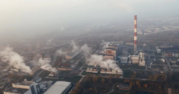 Factory chimney releasing smoke, representing air pollution as a major global environmental issue caused by industrial emissions.