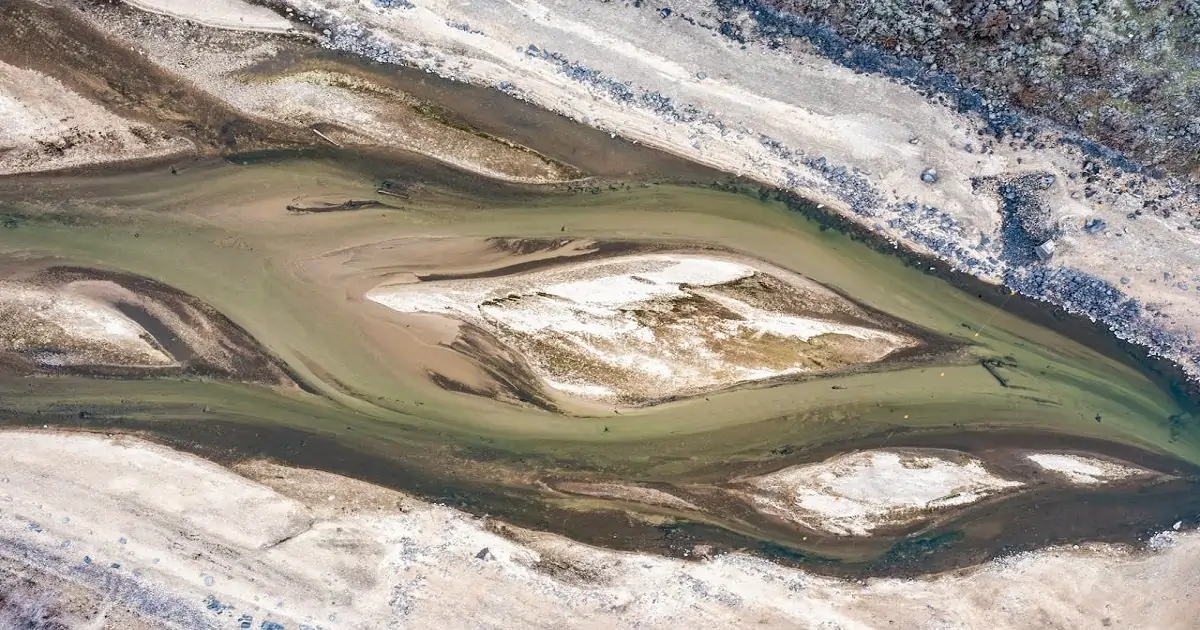 Aerial view of a degraded river channel showing habitat loss and environmental stress