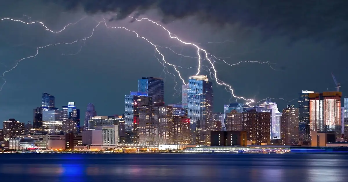 Thunderstorm with lightning over a city representing natural sources of noise pollution